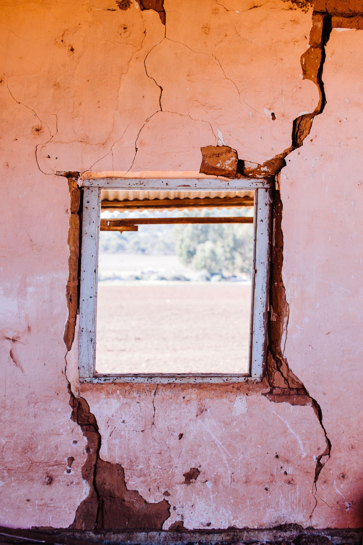 Large crack radiating from a window opening in an exterior wall