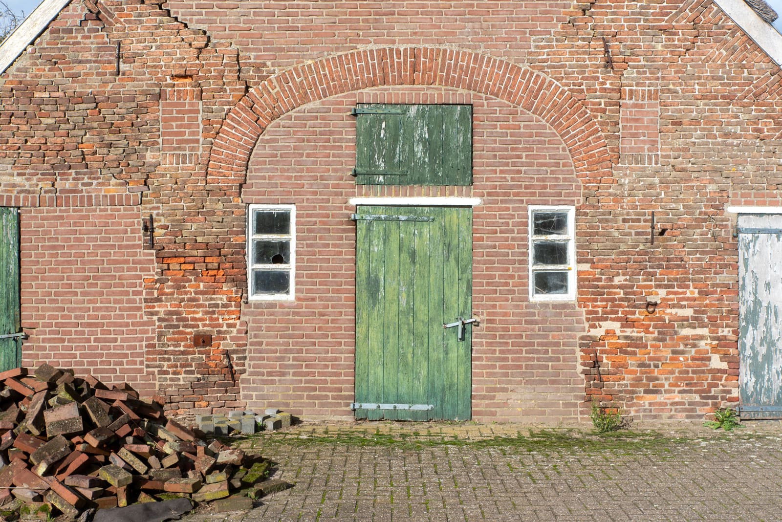 Large stepped crack running through a brick wall